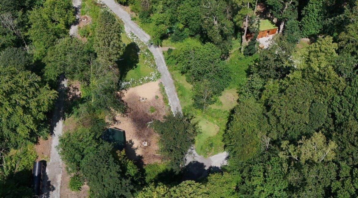 Aerial view of Tree Tops and Train Tracks woodland campsite set within 18 acres of North Wales countryside
