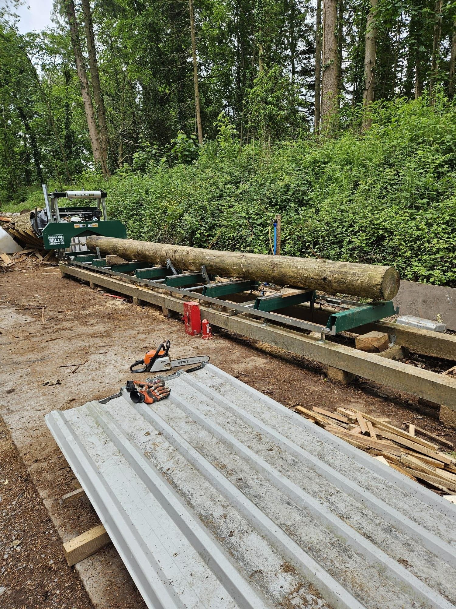Woodland Mills sawmill processing a whole log into timber at Tree Tops and Train Tracks in North Wales