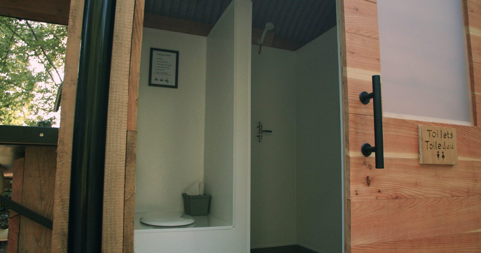 Clean compost toilet facilities at an off-grid woodland campsite in North Wales