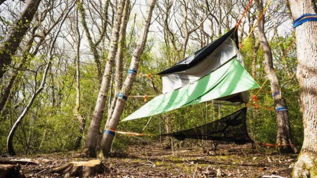 Tentsile tree tent suspended between trees at Tree Tops and Train Tracks woodland glamping site in North Wales